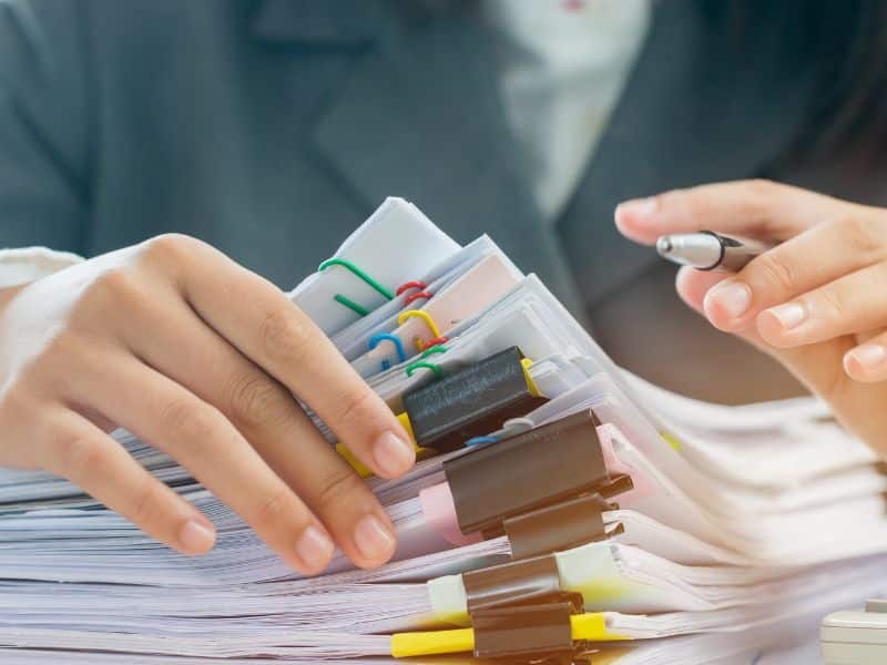 auditor going through stack of paper